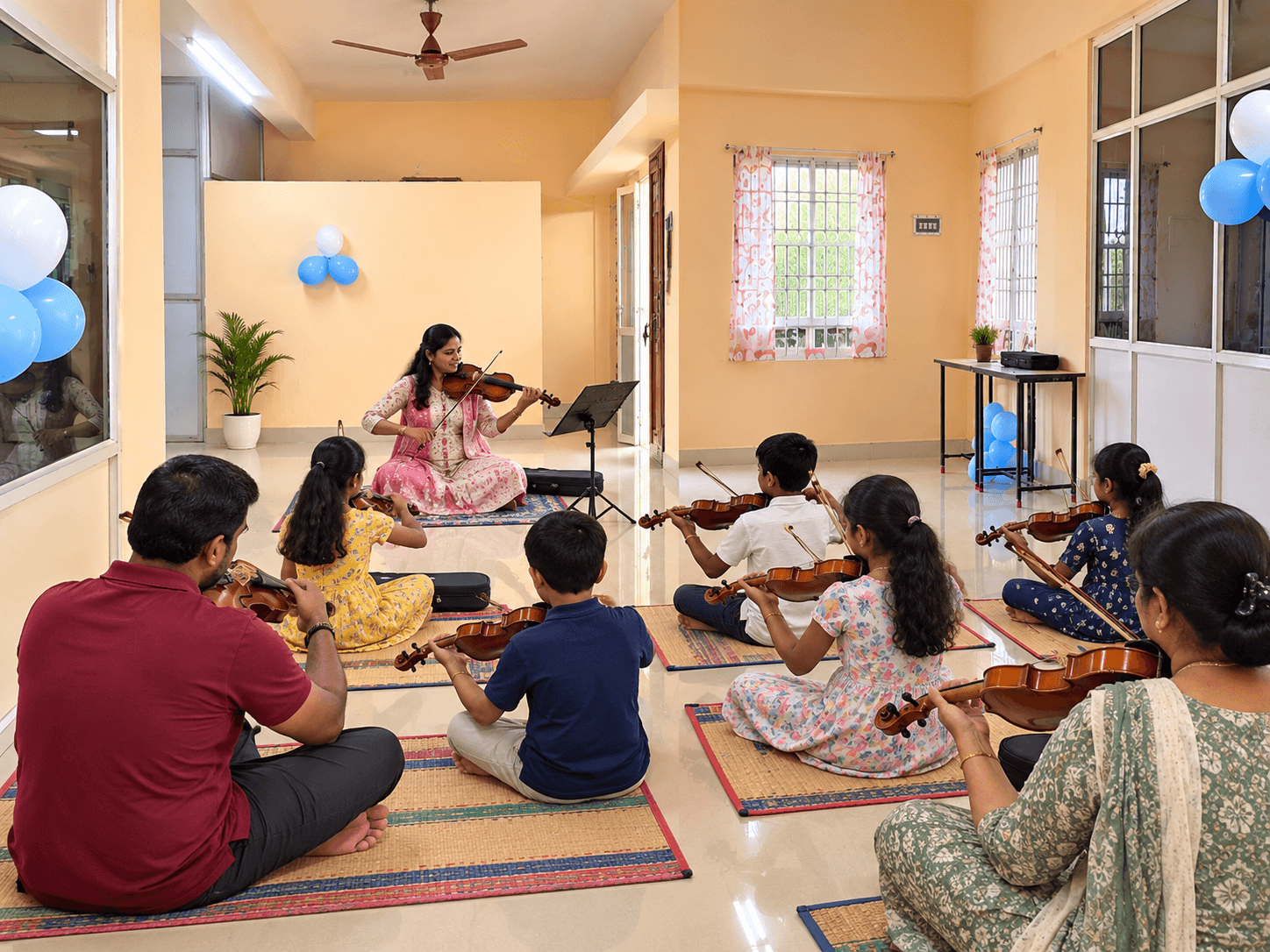 Violin class seated on mats, following the teacher